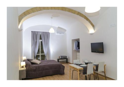 een slaapkamer met een bed en een eetkamer bij Centro Storico Napoletano in Napels