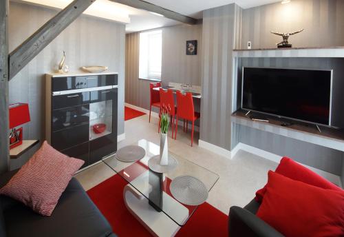 a living room with a couch and a tv at Ferienhof Elbaue in Schönebeck