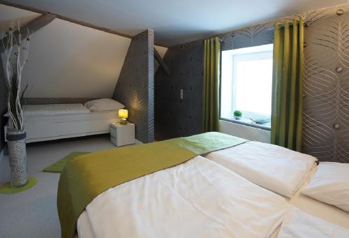a bedroom with a large bed and a window at Ferienhof Elbaue in Schönebeck