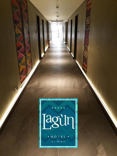 a long hallway with a sign on the floor at Lagùn Hotel in El Nido