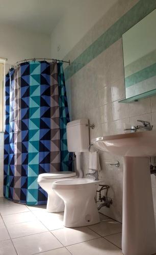 a bathroom with a toilet and a sink at Tindari Village Camping in Furnari