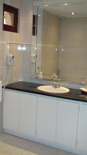 a bathroom with a sink and a mirror at Boutique Hotel Palacio in Santo Domingo