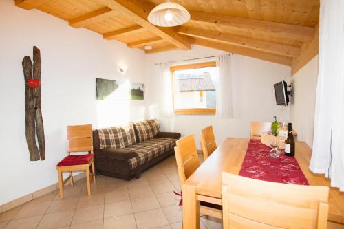 a living room with a table and a couch at Schötzerhof in Meltina