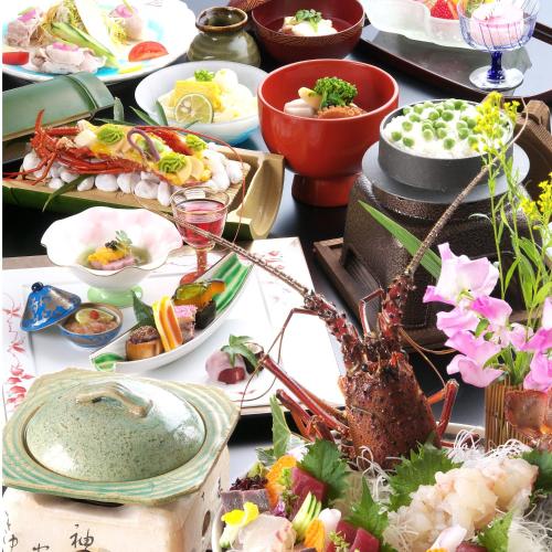 a table with many plates of food on it at Kotohira Onsen Kotosankaku in Kotohira