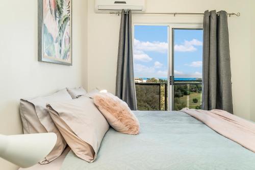 a bedroom with a bed with a large window at Huge CBD Top Floor Apartment with Breath Taking Views! in Darwin
