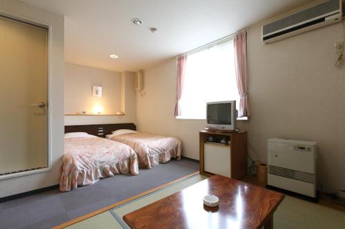 Säng eller sängar i ett rum på Resort Inn North Country