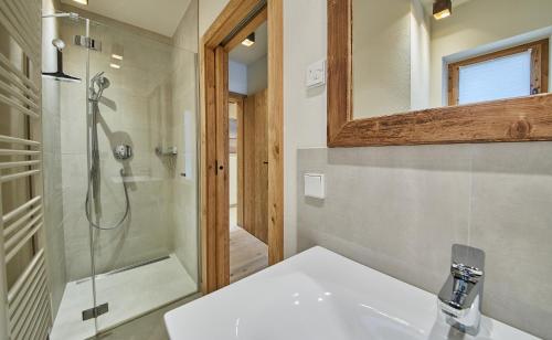 a bathroom with a sink and a shower at Chalet Guter Hirte in Saalbach Hinterglemm