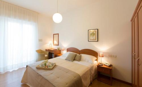 Postel nebo postele na pokoji v ubytování Hotel Giulietta