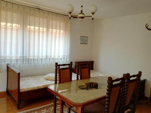a dining room with a table and a bed at Apartment Marchela in Nesebar