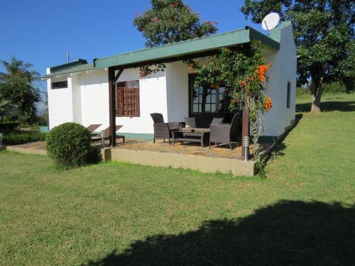 a small white house with a table and chairs at White House Lodge in White River