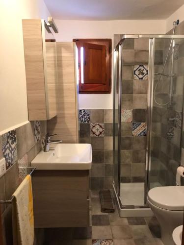 a bathroom with a sink and a shower at Mursia Casa Vacanze in Pantelleria