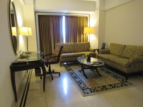 a living room with a couch and a table at Eros Hotel New Delhi, Nehru Place in New Delhi