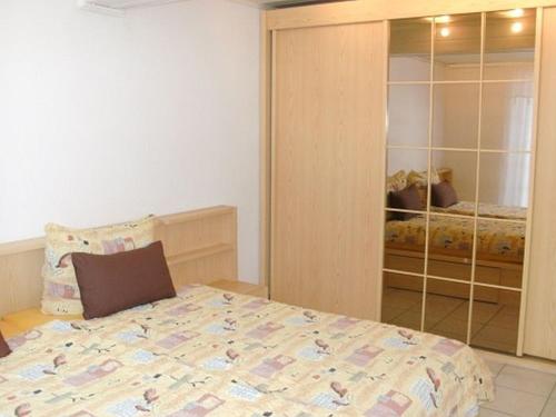 a bedroom with a bed and a closet with a closetessions at Ferienwohnung Sonnenblick in Eisenbach