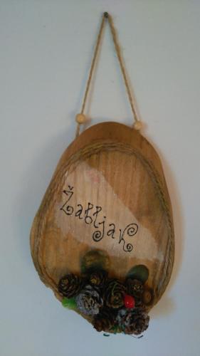 a wooden object with a sign on a wall at Eco house in Žabljak