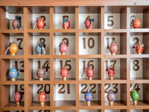 a shelf of vases with numbers on them at Hotel&SPA Pysanka, Готель Писанка, 3 сауни та джакузі - індивідуальний відпочинок у СПА in Lviv