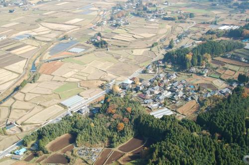 an aerial view of a village with trees and houses at Ryokoji Temple in Minami Aso