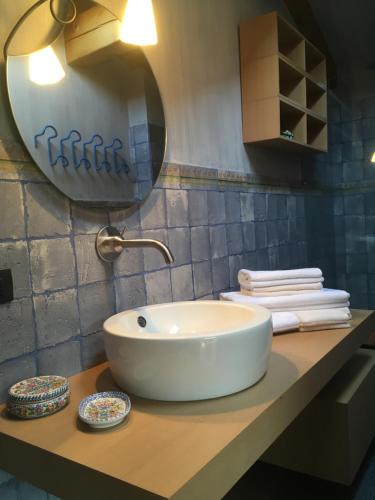 a white sink on a counter in a bathroom at Suite Ananda in Verbania