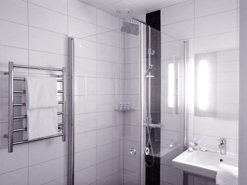 a bathroom with a shower and a sink at Forenom Aparthotel Gothenburg Nolvik in Säve