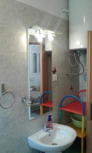 a bathroom with a sink and a mirror at Danijela Apartmani in Čanj