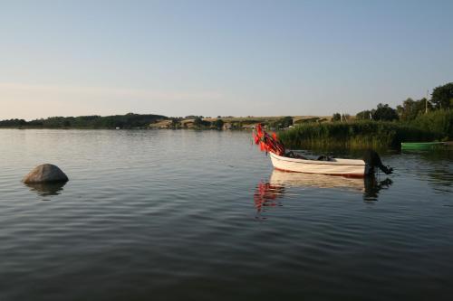 a small boat sitting in the middle of a lake at Hotel Boje06 in Heringsdorf