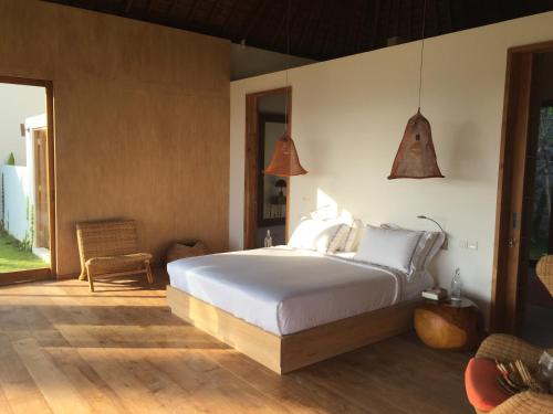 a bedroom with a large bed in a room at Balian Prana in Selemadeg