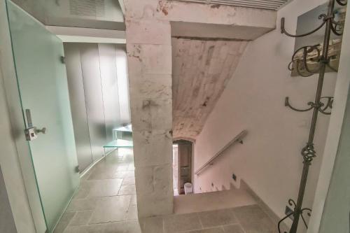 a hallway with a stone pillar in a building at Dimora Lumi in Locorotondo