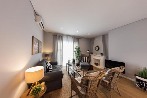 a living room with a couch and chairs at Quinta da Salada - Alojamento Local Douro in Peso da Régua