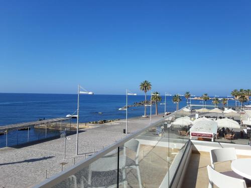 a balcony with a view of a beach and the ocean at Lighthouse by the Sea Lovely 2Bdr Apartment in Paphos City
