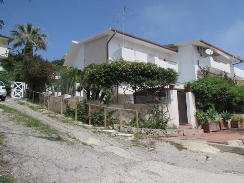 a white house with a fence in front of it at Villa Majata in Realmonte