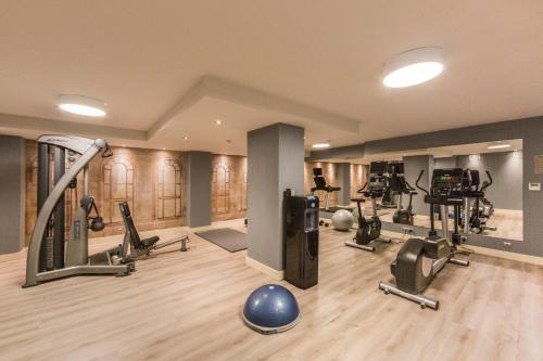 a gym with several treadmills and exercise machines at Catalonia Granada in Granada