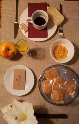 a table with plates of food and a cup of coffee at Peregrinando, pensión con encanto in Navarrete