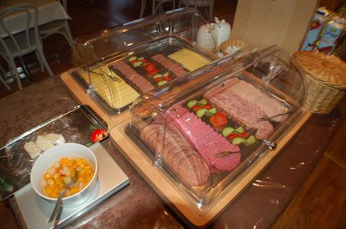 a buffet with meat and other foods on a table at Hotell Marieberg in Kristinehamn