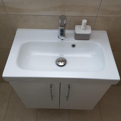 a white sink with a faucet in a bathroom at Lighthouse by the Sea Lovely 2Bdr Apartment in Paphos City
