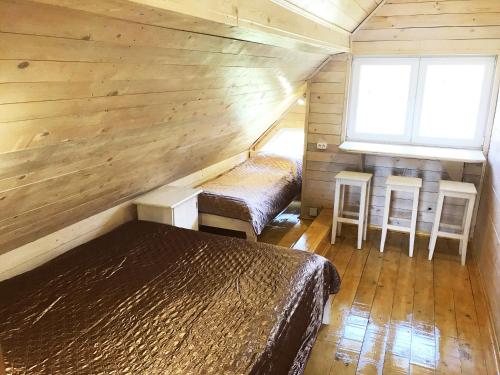 a room with two beds in a wooden cabin at Stare Selo in Kolochava