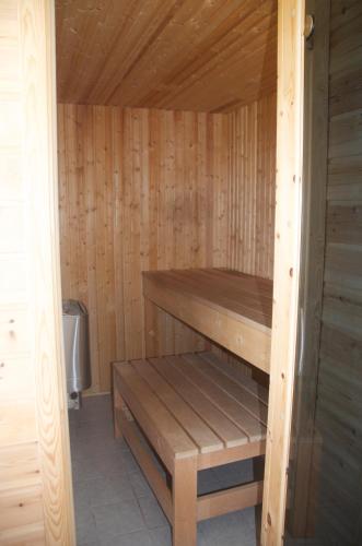 a wooden sauna with a bench in it at Seljenes Cottage in Russenes