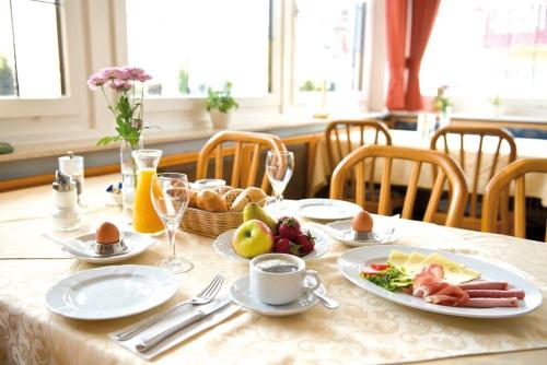a table with plates of food on top at Hotel Gasthof Rössle in Rottenburg