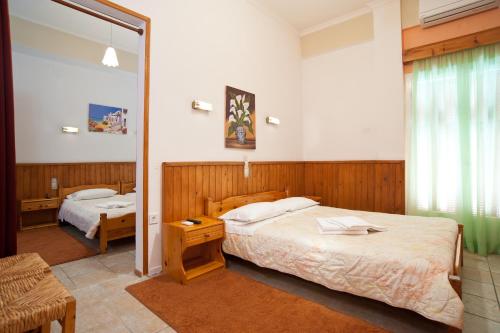 Postel nebo postele na pokoji v ubytování Hotel Athina