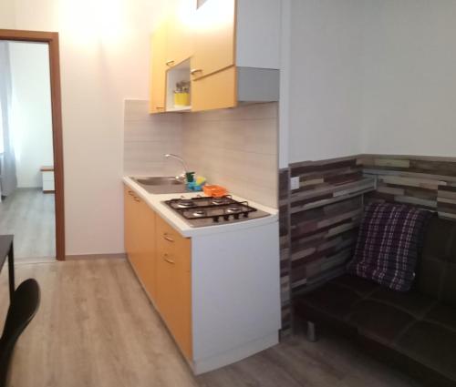 a small kitchen with a stove and a sink at Archimede in Pavia