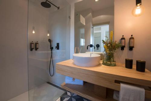 a bathroom with a sink and a shower at Herdade Do Touril in Zambujeira do Mar