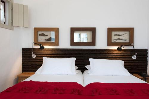 a bed with two white pillows in a room at Herdade Do Touril in Zambujeira do Mar