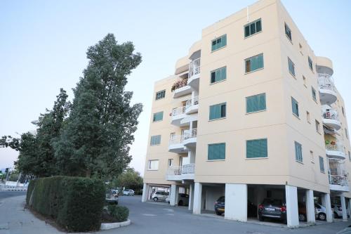 ニコシアにあるBianco E U Apartmentの前に車が駐車されている高い建物
