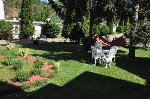 two chairs and a hammock in a yard at Vila Kraljica in Vrdnik