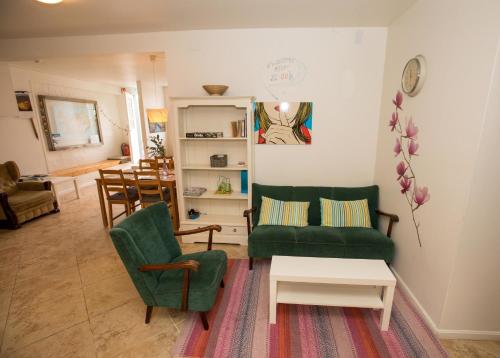 a living room with two green chairs and a table at Central Guesthouse Reykjavík in Reykjavík