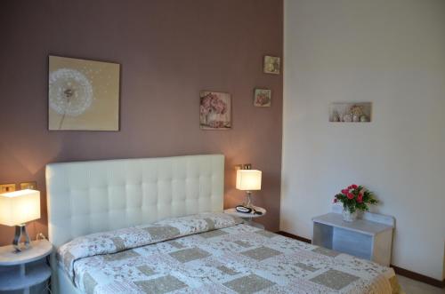 a bedroom with a bed with two tables and two lamps at Hotel President in Chianciano Terme