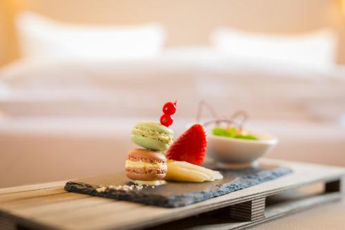 a plate of food with fruit on a table at Hotel Krämerbrücke Erfurt in Erfurt