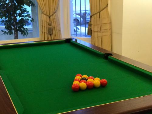
A pool table at OYO The Strand Hotel

