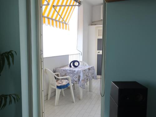 a dining room with a table and a table and chairs at Turchese in Amalfi