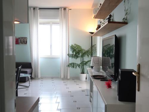 a living room with a desk and a window at Turchese in Amalfi