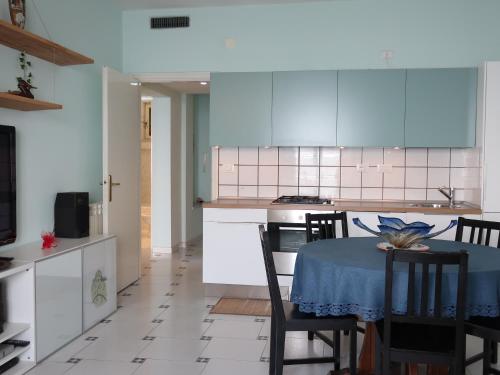 a kitchen and dining room with a table and chairs at Turchese in Amalfi
