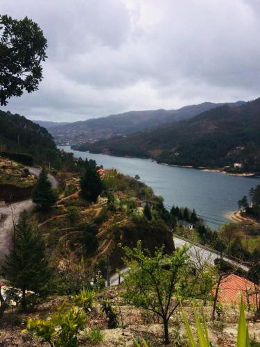 a view of a lake from a hill with trees at Vale de Azereiros Apartamentos in Geres